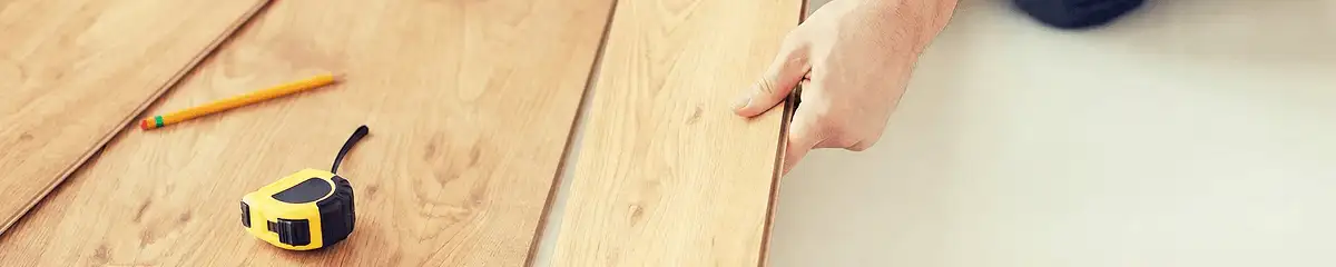 A professional installing wood flooring in Buffalo, NY