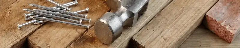 Hammer and nails on hardwood flooring boards in Buffalo, NY