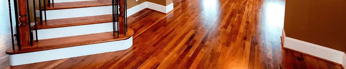 Base floor of a staircase with professionally restored wood flooring in Buffalo NY