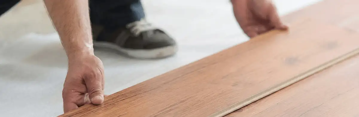 A professional installing laminate flooring in Buffalo, NY
