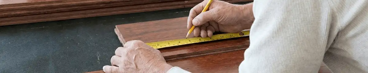 A professional installing wood flooring in Buffalo, NY
